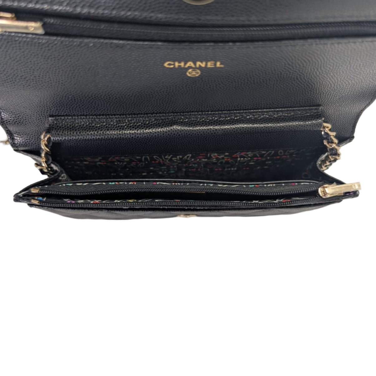 Black Chanel handbag with gold chain on a white background