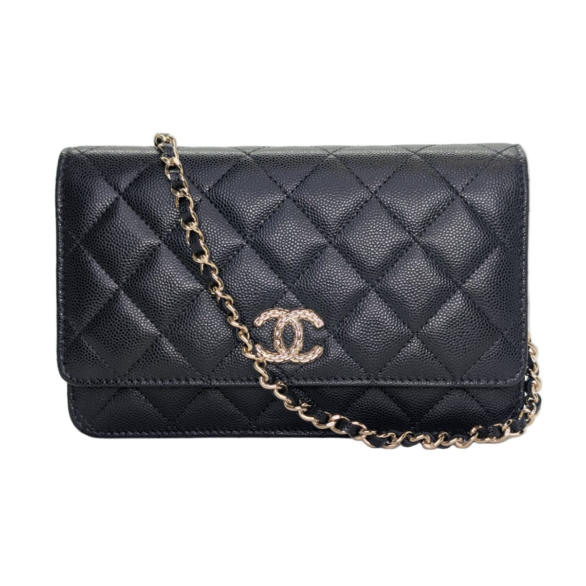 Black quilted handbag with gold chain and Chanel logo on a white background